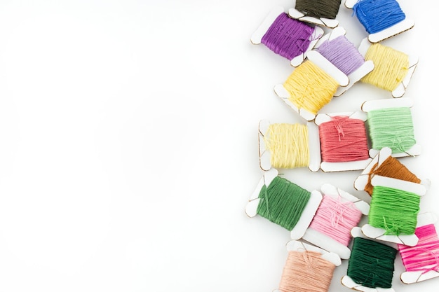 Selection of colorful embroidery threads on a wooden table